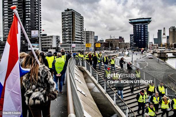 Protestors wearing "yellow vests" demonstrate next to the Erasmusbrug in Rotterdam, The Netherlands, on December 8, 2018. - The so-called "gilets...