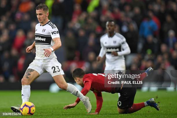 Fulham's English defender Joe Bryan runs away from Manchester United's Portuguese defender Diogo Dalot during the English Premier League football...