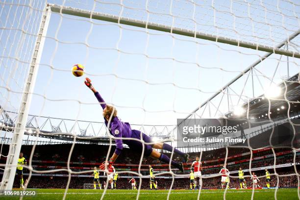 Jonas Lossl of Huddersfield Town dives to make a save during the Premier League match between Arsenal FC and Huddersfield Town at Emirates Stadium on...