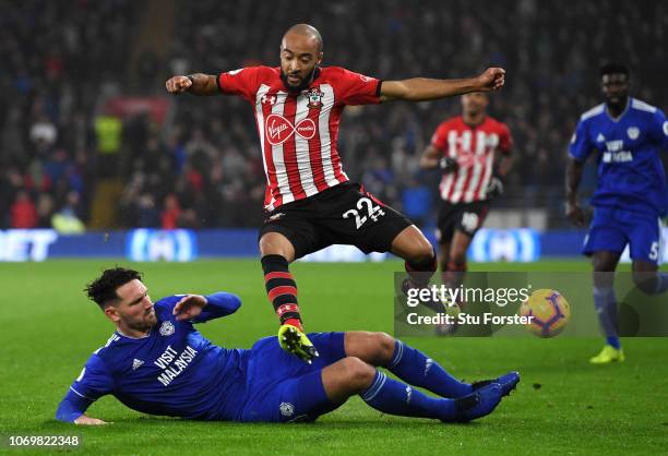 Sean Morrison of Cardiff City tackles Nathan Redmond of Southampton during the Premier League match between Cardiff City and Southampton FC at...