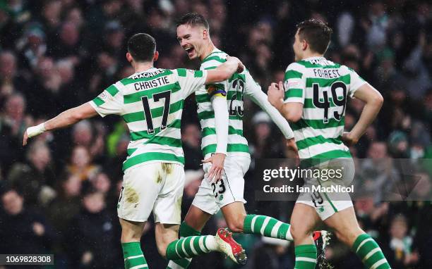 Mikael Lustig of Celtic celebrates with Ryan Christie after he scores his team's fourth goal during the Scottish Ladbrokes Premiership match between...