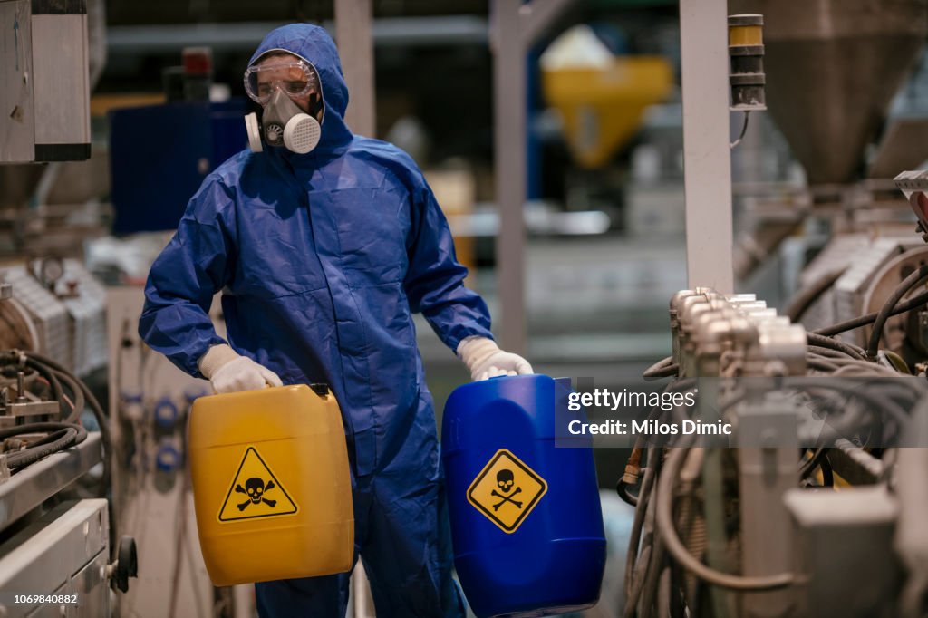 Factory worker working with dangerous materials
