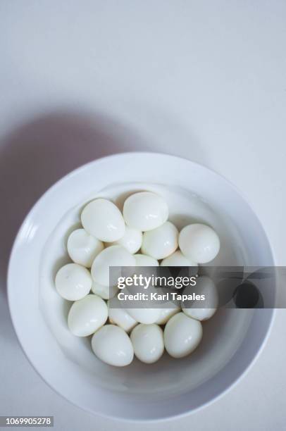 a bunch of quail eggs on a white bowl - boiled egg stock pictures, royalty-free photos & images