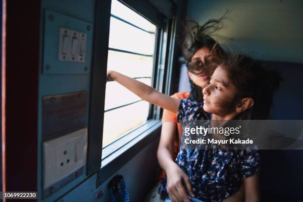 Mother and daughter travelling by train
