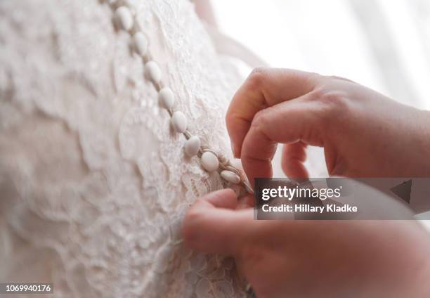 buttoning up wedding dress - bride getting dressed stock pictures, royalty-free photos & images