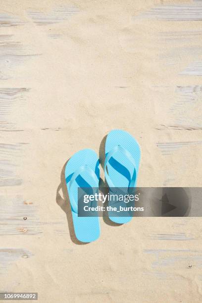 high angle view of boardwalk with sand and turquoise flip-flops - blue shoe bildbanksfoton och bilder