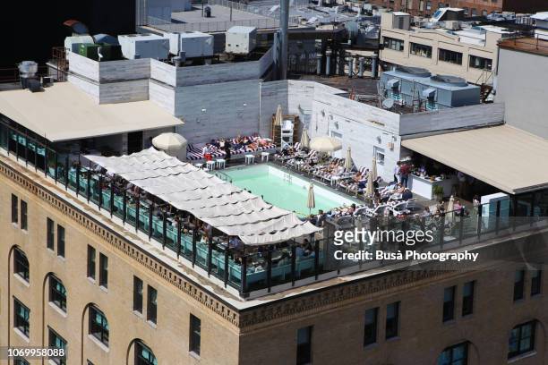 bird's eye view of  the rooftop pool of the soho house new york, on 9th avenue in the meatpacking district, manhattan, new york city - soho house club stock-fotos und bilder