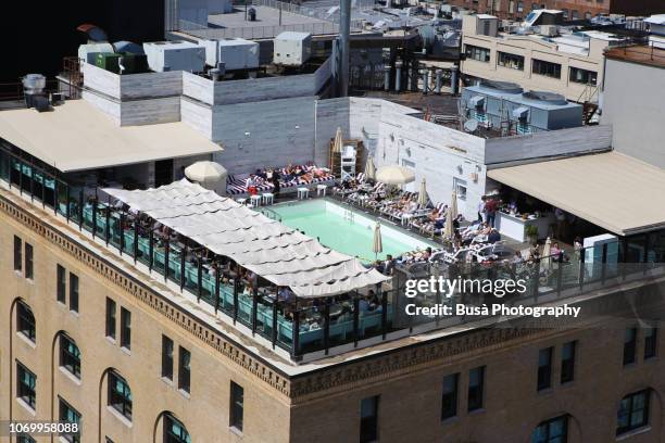 bird's eye view of the rooftop pool of the soho house new york, on 9th avenue in the meatpacking district, manhattan, new york city - soho house club stockfoto's en -beelden