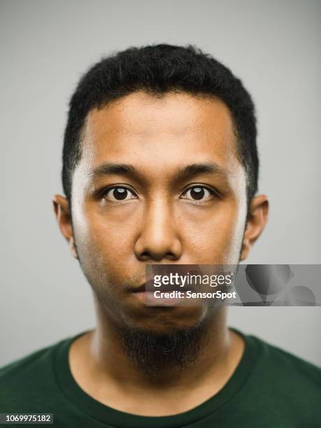 real arabic young man with blank expression - mug shot stock pictures, royalty-free photos & images