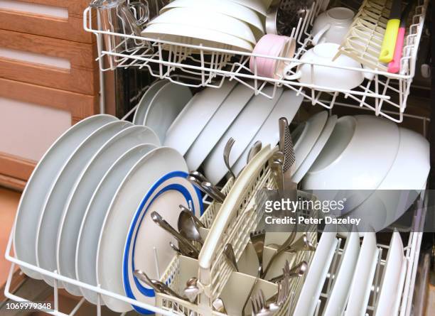 dishwasher with clean dishes - dishwasher stock pictures, royalty-free photos & images