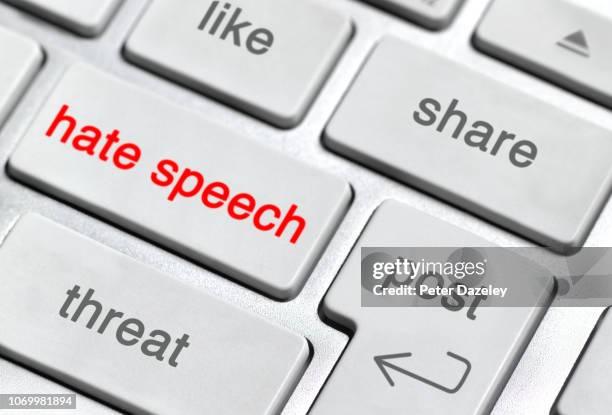 hate speech on keyboard - furioso foto e immagini stock