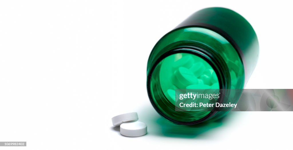 Opioid Pills in Green Medicine Bottle