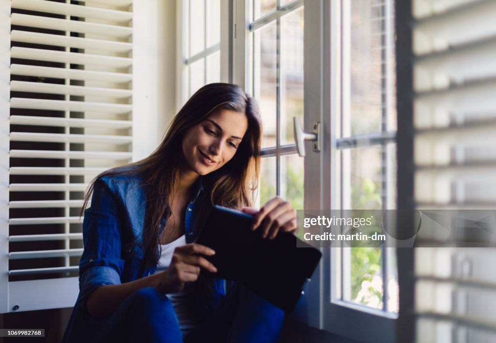 Woman at home reading a book