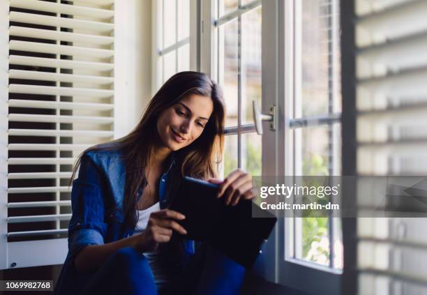 woman at home reading a book - shutter stock pictures, royalty-free photos & images