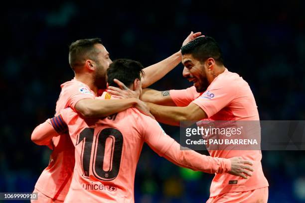 Barcelona's Argentinian forward Lionel Messi celebrates with Barcelona's Spanish defender Jordi Alba and Barcelona's Uruguayan forward Luis Suarez...