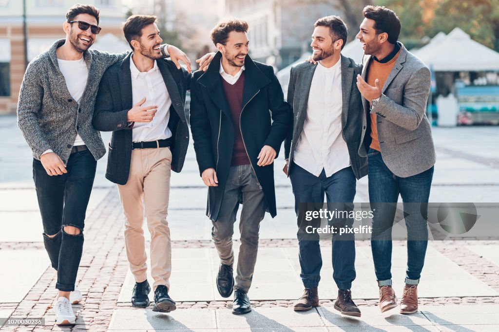 Group of cheerful male friends on the street