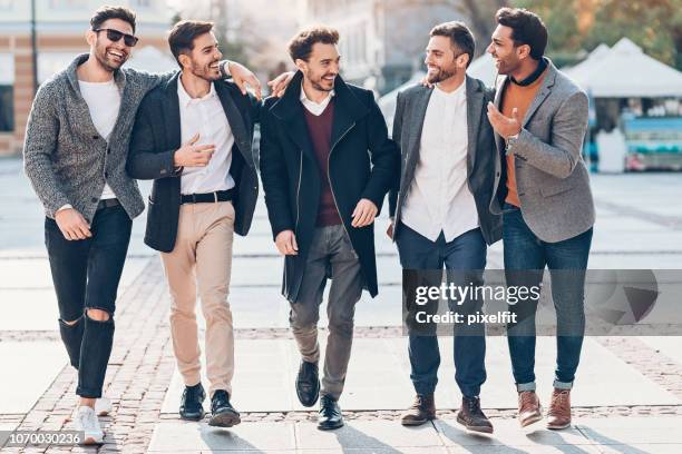 group of cheerful male friends on the street - stag stock pictures, royalty-free photos & images