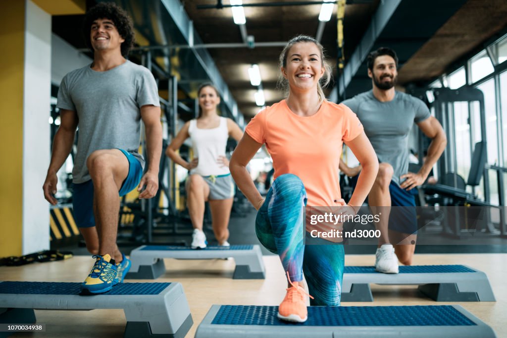 Group of young people doing exercises in gym