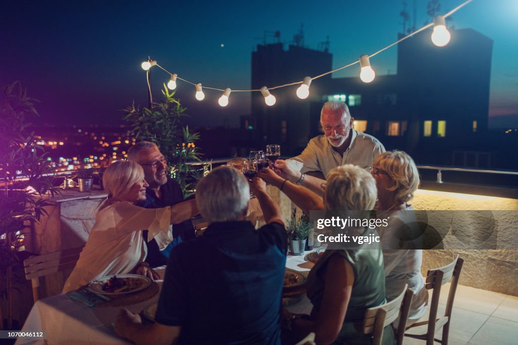 Seniors Having Dinner On Rooftop