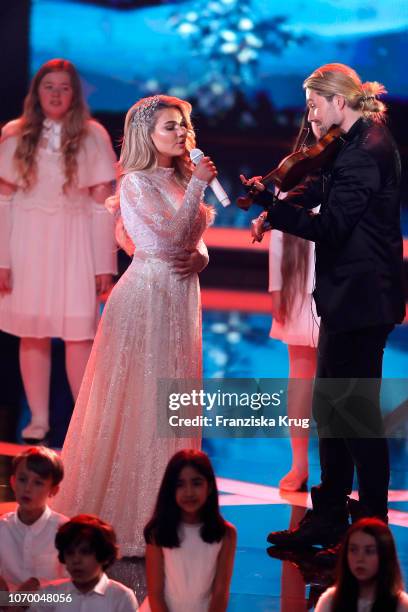 Shirin David and David Garrett perform at the Ein Herz Fuer Kinder Gala show at Studio Berlin Adlershof on December 8, 2018 in Berlin, Germany.