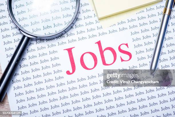 job search concept, hand holding magnifying glass for search jobs. - vacancy stock pictures, royalty-free photos & images