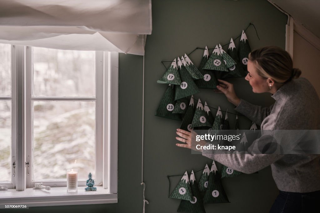 Woman with christmas calendar with gifts
