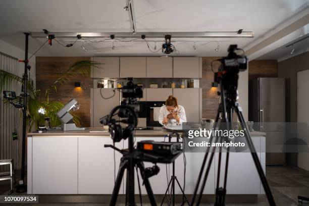 tv set studio kitchen female cook preparing cookies - film set stock pictures, royalty-free photos & images