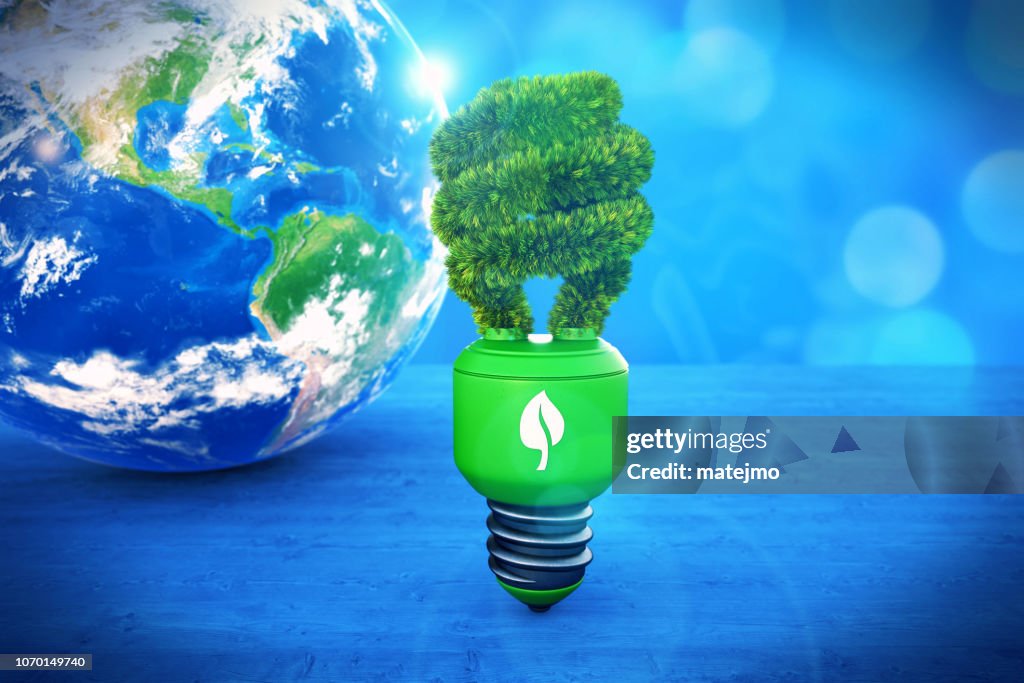 Abstract scene with Earth and a neon light bulb on bokeh blue background