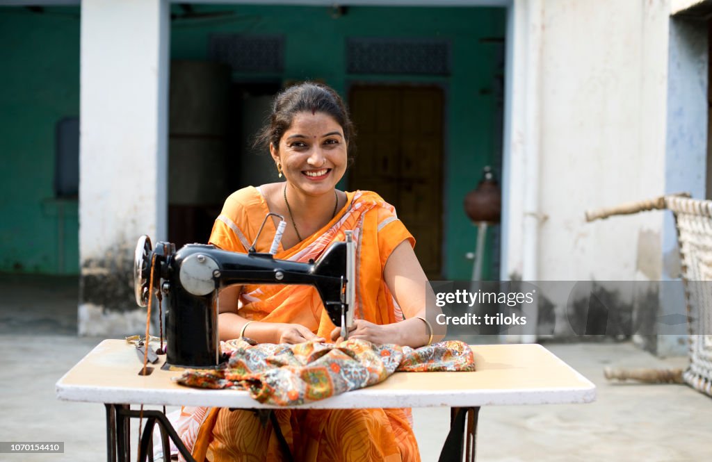 Woman sewing clothes with sewing machine
