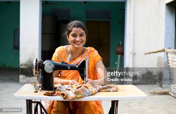 woman sewing clothes with sewing machine - rural scene stock pictures, royalty-free photos & images