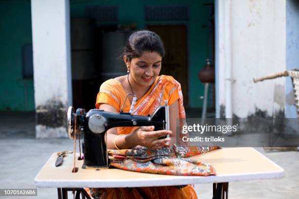 woman sewing clothes with sewing machine - indian village people stock pictures, royalty-free photos & images