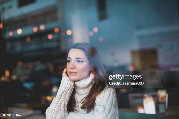 lonely girl in cafe - winter sadness stock pictures, royalty-free photos & images