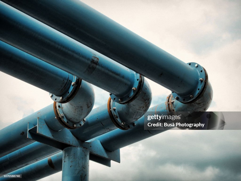 Detail of giant blue-colored water pipes, a peculiar system used to pump away ground-water from flooded foundations of construction sites.