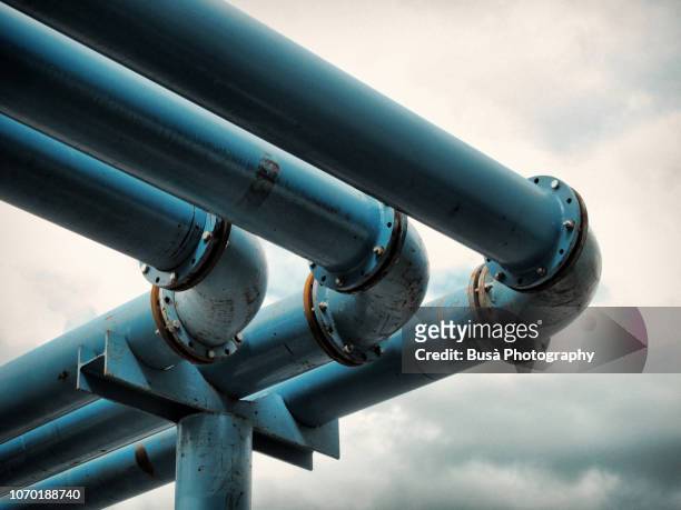 detail of giant blue-colored water pipes, a peculiar system used to pump away ground-water from flooded foundations of construction sites. - oleodotto foto e immagini stock