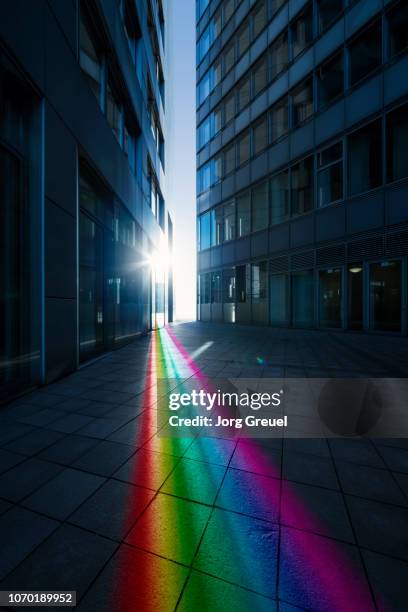 rainbow-colored ray of light - sunbeam city stock pictures, royalty-free photos & images