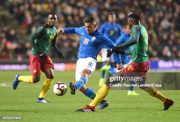 Allan of Brazil is challenged by Yaya Banana of Cameroon during the International Friendly match between Brazil and Cameroon at Stadium mk on...