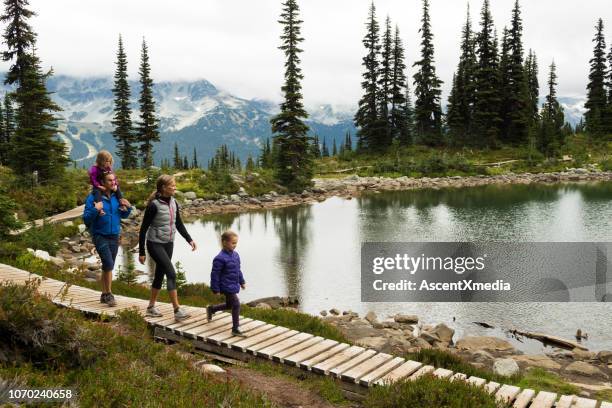 family enjoying a hike in the mountains - canada summer stock pictures, royalty-free photos & images