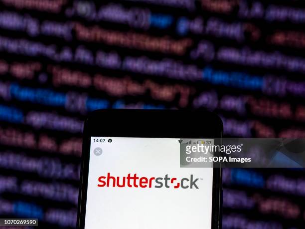 In this photo illustration, the Shutterstock Stock photography company logo seen displayed on a smartphone.