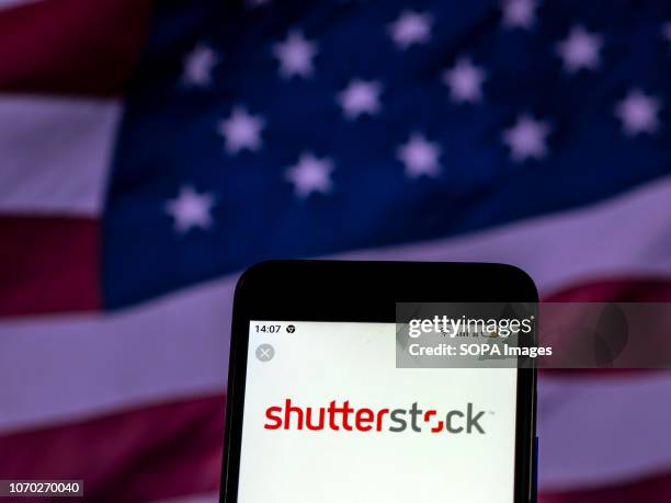 In this photo illustration, the Shutterstock Stock photography company logo seen displayed on a smartphone.