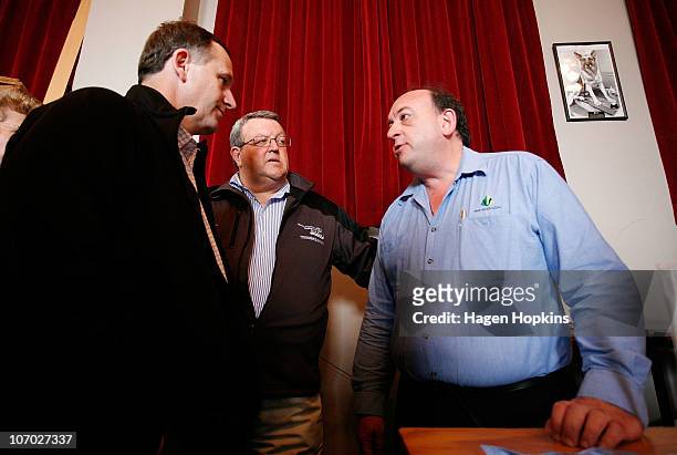 Of Pike River Coal Peter Whittall talks to New Zealand Prime Minister John Key while Minister of Energy and Resources Gerry Brownlee looks on at...