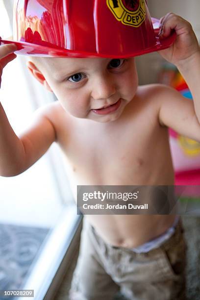 firefighter boy - firefighters helmet stock pictures, royalty-free photos & images