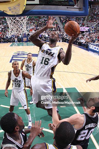 Francisco Elson of the Utah Jazz goes for the layup over Manu Ginobili of the San Antonio Spurs at EnergySolutions Arena on November 19, 2010 in Salt...
