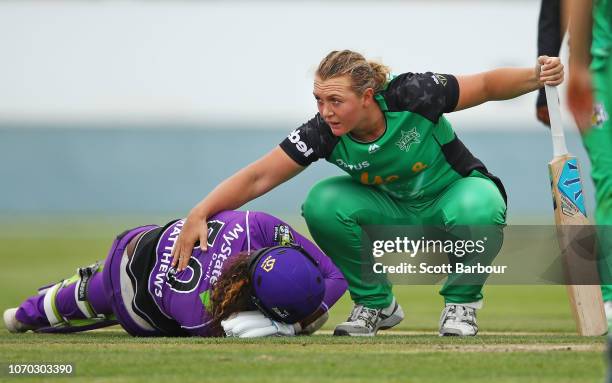 Bowler Nicola Hancock of the Stars consoles Hayley Matthews of the Hurricanes after running her out and Matthews injured herself during the Women's...