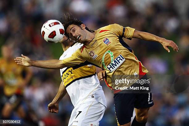 Marcello Fiorentini of the Jets heads the ball in front of Leo Bertos of the Phoenix during the round 15 A-League match between the Newcastle Jets...