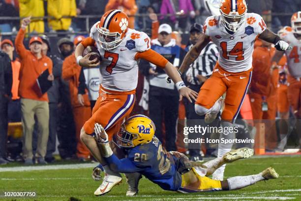 Clemson Tigers quarterback Chase Brice escapes a tackle attempt by Pittsburgh Panthers defensive back Dennis Briggs during the ACC Championship game...