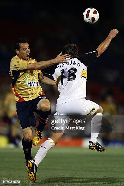 Sasho Petrovski of the Jets clashes with Ben Sigmund of the Phoenix during the round 15 A-League match between the Newcastle Jets and the Wellington...