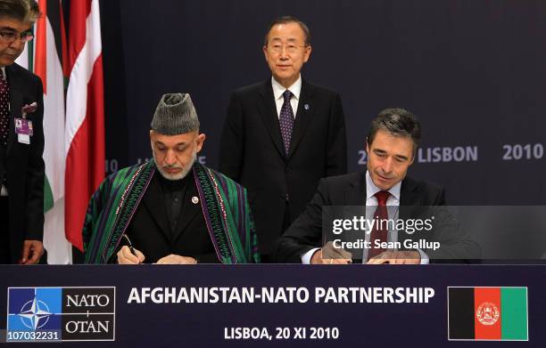 Afghanistan President Hamid Karzai and NATO Secretary General Anders Fogh Rasmussen sign a declaration for the Afghanistan-NATO partnership as United...