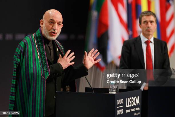 Afghanistan President Hamid Karzai speaks to the media as NATO Secretary General Anders Fogh Rasmussen looks on at the 2010 NATO Summit on November...