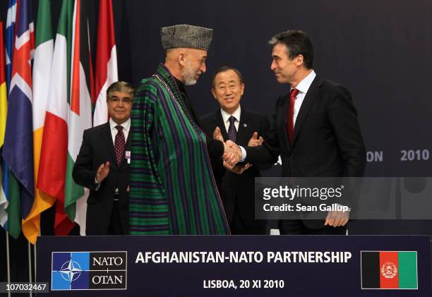 Afghanistan President Hamid Karzai and NATO Secretary General Anders Fogh Rasmussen shake hands after signing a declaration for the Afghanistan-NATO...