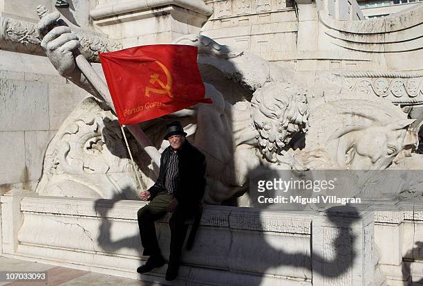 Protestor holds a flag of the Portuguese communist party prior to a demonstration against the NATO summit on November 20, 2010 in Lisbon, Portugal....